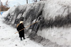 雪の壁に水墨画を描く早津剛さんの画像