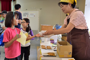 よし太くん焼きをもらう子どもの画像